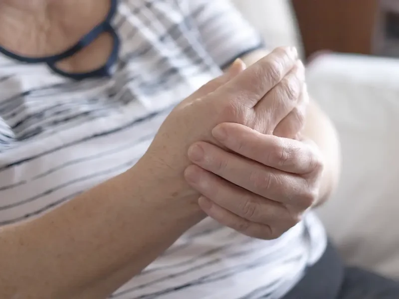 Physical therapist assessing a patient's joint mobility for arthritis