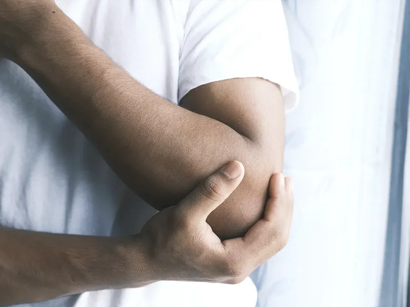 Physical therapist assessing a patient's wrist and hand movement and mobility
