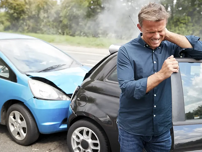 Physical therapist evaluating a patient's neck and back after a motor vehicle accident