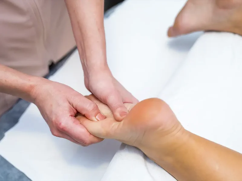 Physical therapist assessing a patient's foot and ankle movement