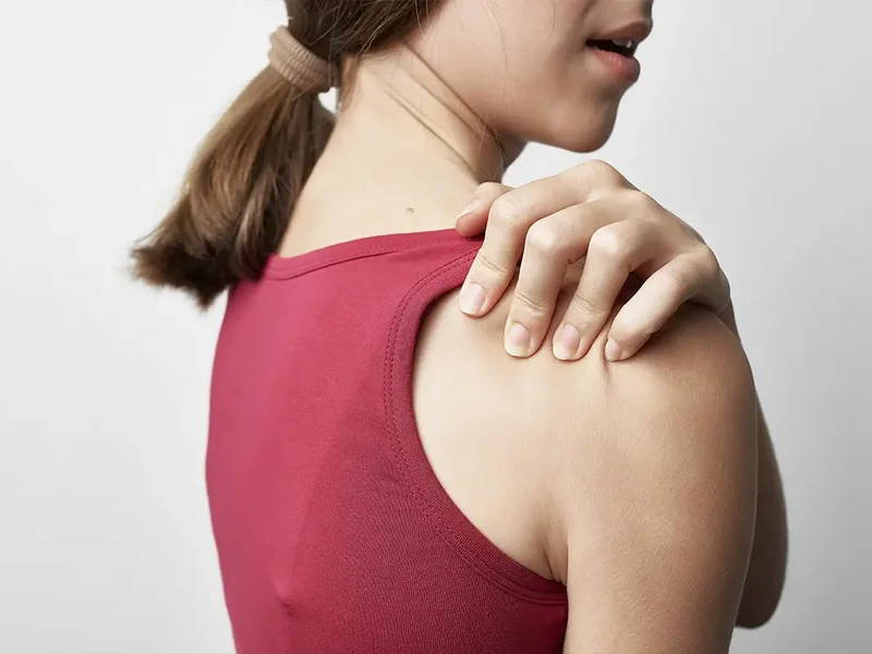 Physical therapist assessing a patient's shoulder movement and mobility