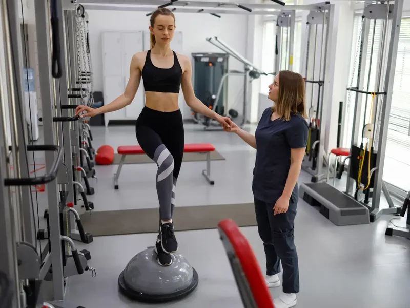 Doctor of Physical Therapy guiding a patient through a balance and gait training exercise