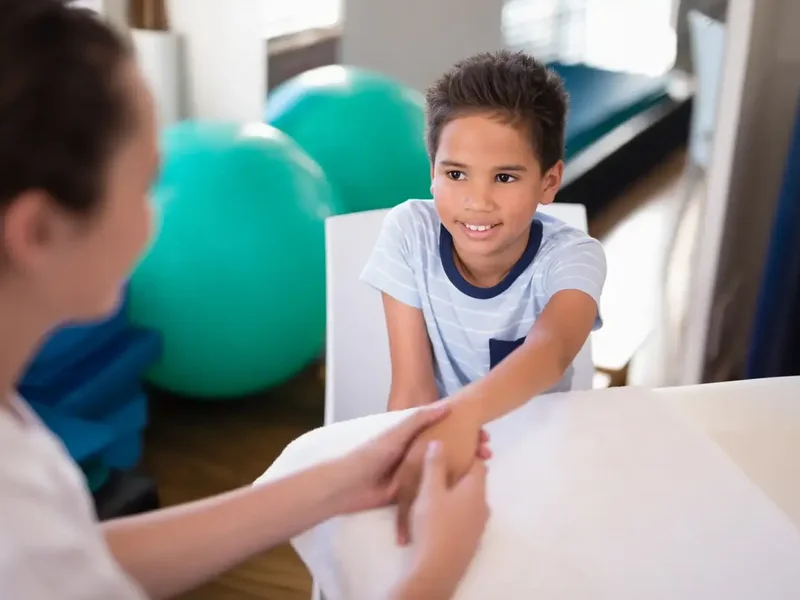 Pediatric physical therapist working with a child on movement skills