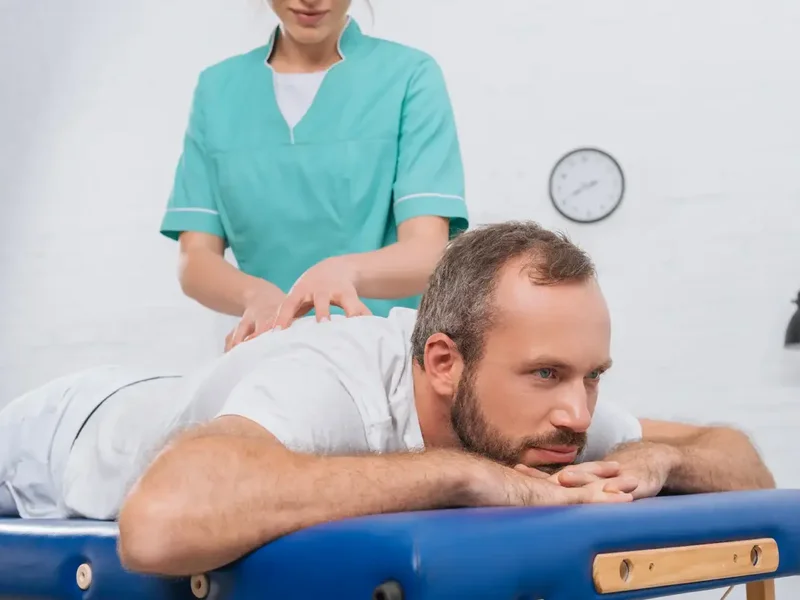 Doctor of Physical Therapy guiding a patient through a McKenzie Method movement assessment
