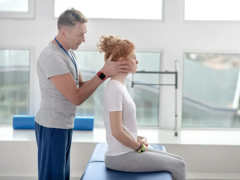 Doctor of Physical Therapy guiding a patient through a vestibular balance exercise